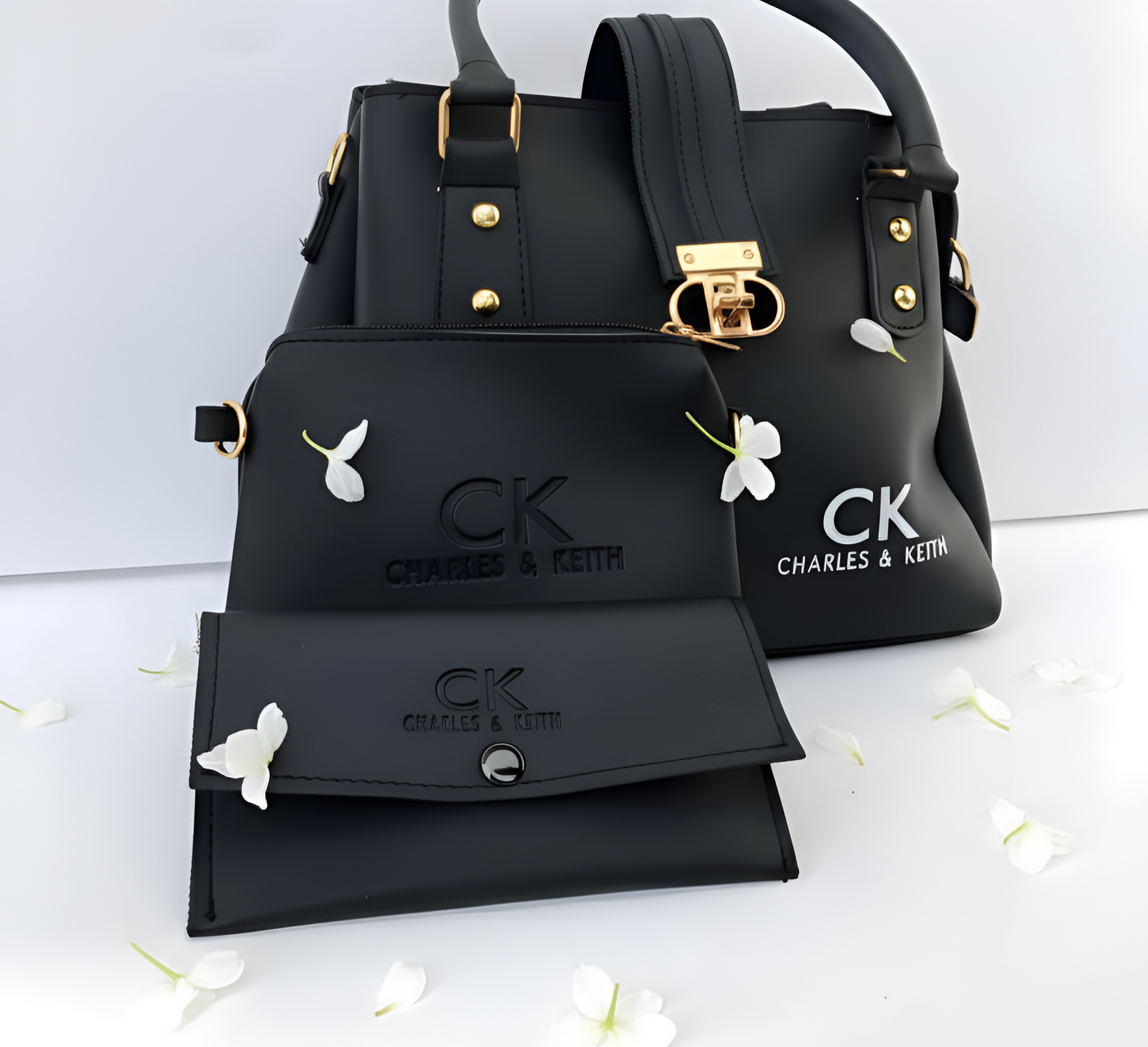 Black handbag and wallet set with 'CK' branding on a white background