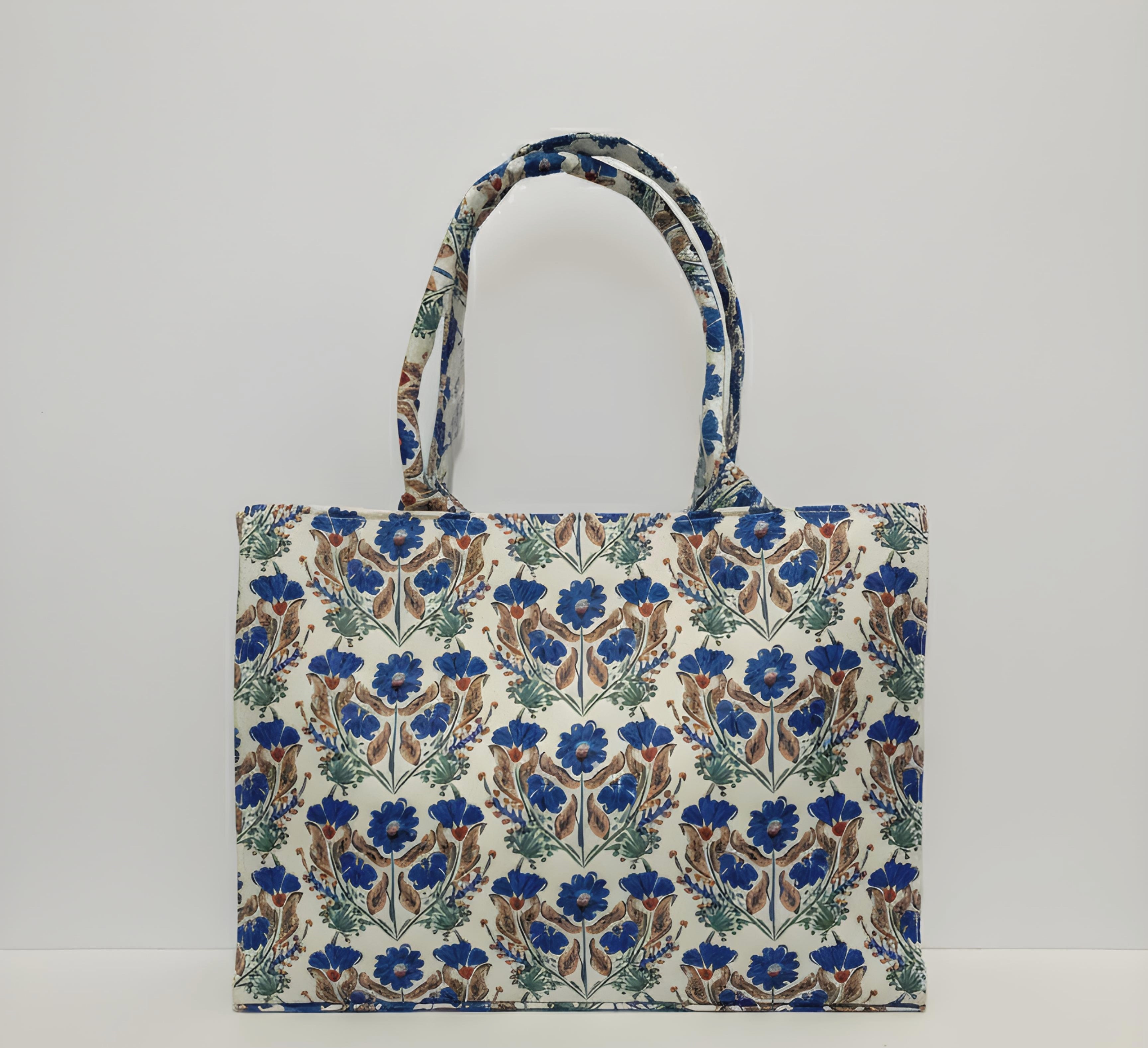 A floral-patterned canvas tote bag featuring blue and brown flowers with sturdy handles for easy carrying.