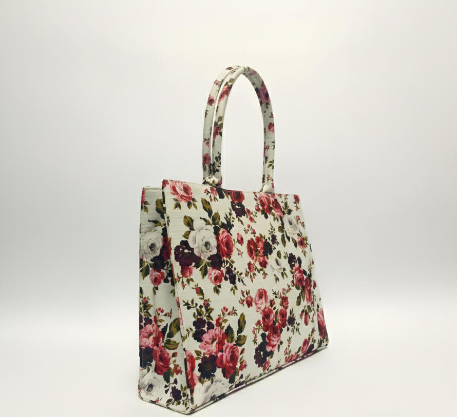 A stylish canvas tote bag with beautiful red and pink rose print on a white background, Conveys a chic and feminine tone.
