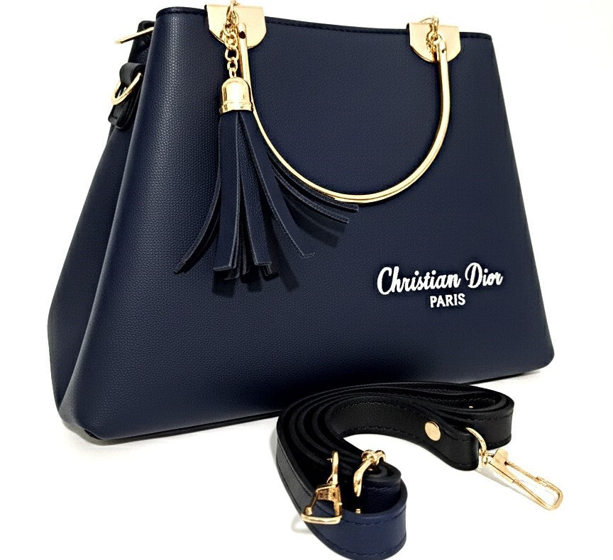 A navy blue Christian Dior handbag featuring gold accents, a decorative tassel, and a detachable strap.
