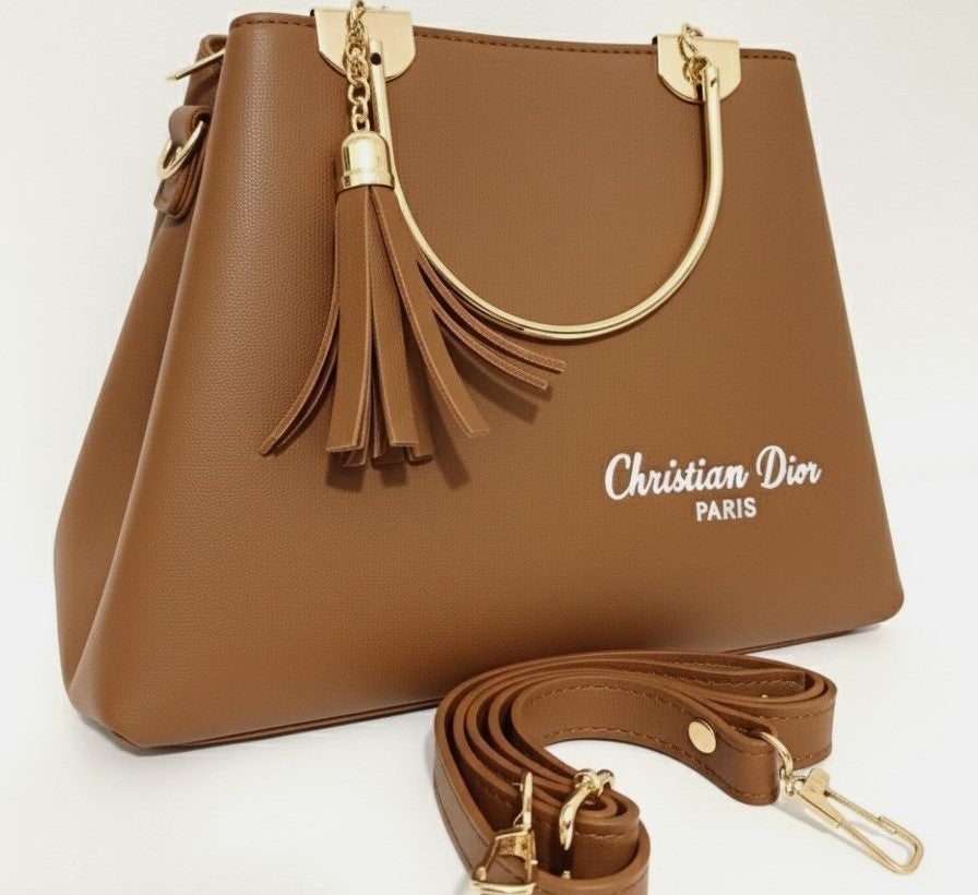 Brown luxury handbag for ladies with gold handles and tassel, featuring "Christian Dior Paris" text and matching strap.