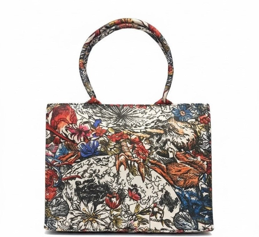 A canvas tote bag with complicated floral and animal patterns in red, blue, and orange. The design is detailed and artistic.