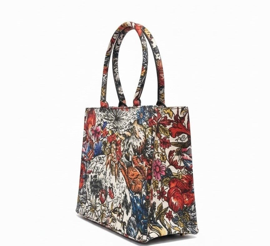 Canvas tote bag with dual handles, featuring a complicated floral pattern in red, blue, and gold tones on a white background. Elegant and artistic design.